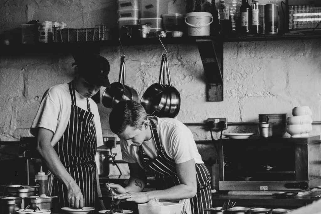 Chefs preparing food in restaurant kitchen