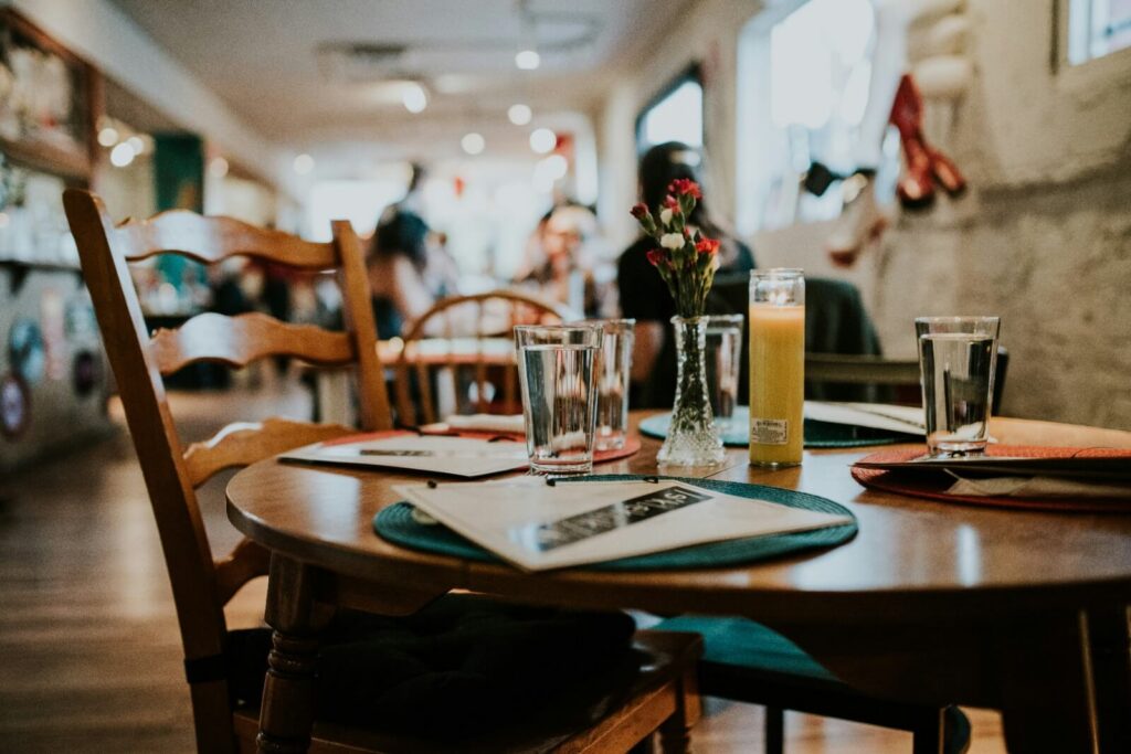 Restaurant table with menu and laptop
